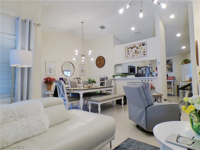 living room with light tile patterned floors, high vaulted ceiling, and an inviting chandelier