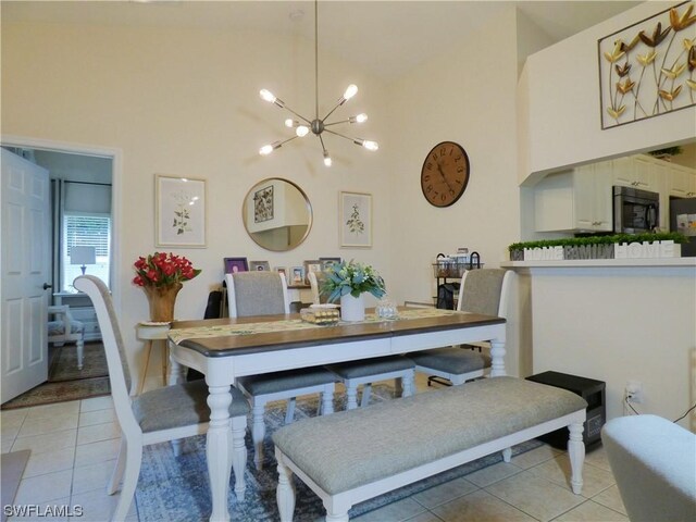 dining area with high vaulted ceiling, light tile patterned floors, and a notable chandelier