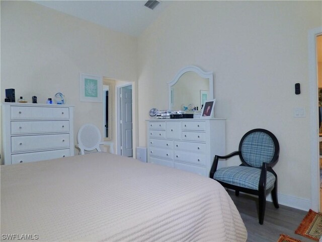 bedroom featuring hardwood / wood-style floors and lofted ceiling