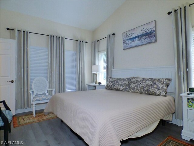 bedroom featuring vaulted ceiling and dark wood-type flooring