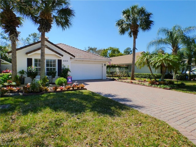 ranch-style house featuring a garage and a front lawn