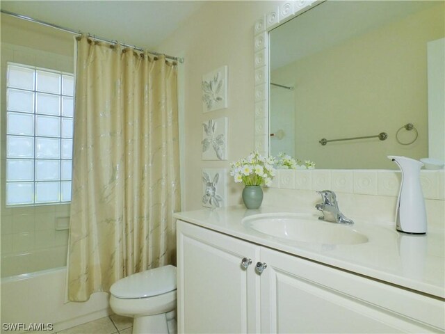 full bathroom with toilet, plenty of natural light, shower / bath combination with curtain, and tile patterned flooring