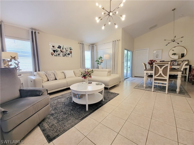 living room featuring ceiling fan with notable chandelier, high vaulted ceiling, and light tile patterned flooring