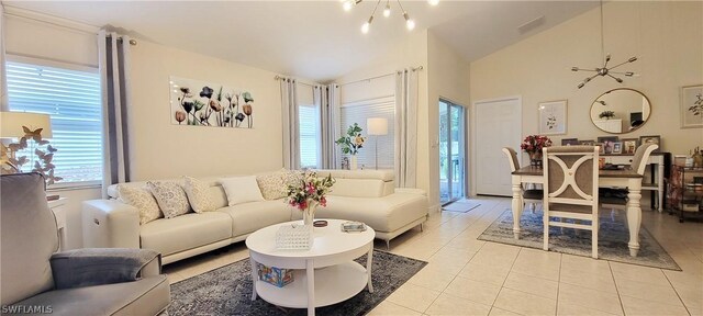 tiled living room with high vaulted ceiling and a notable chandelier