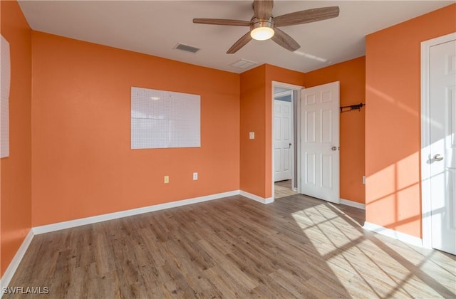 spare room with hardwood / wood-style floors and ceiling fan