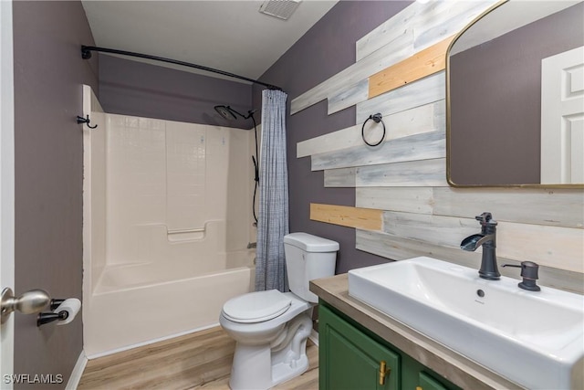 full bathroom with hardwood / wood-style floors, vanity, toilet, and shower / bath combo with shower curtain