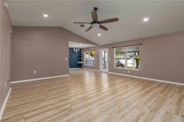 unfurnished living room with ceiling fan with notable chandelier, light hardwood / wood-style floors, and lofted ceiling