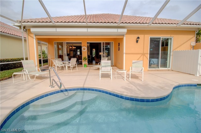 view of swimming pool featuring a patio and a lanai