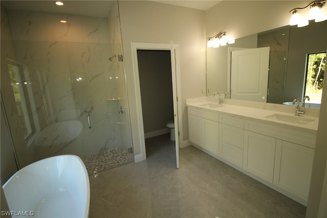 full bathroom featuring plus walk in shower, vanity with extensive cabinet space, double sink, and tile flooring