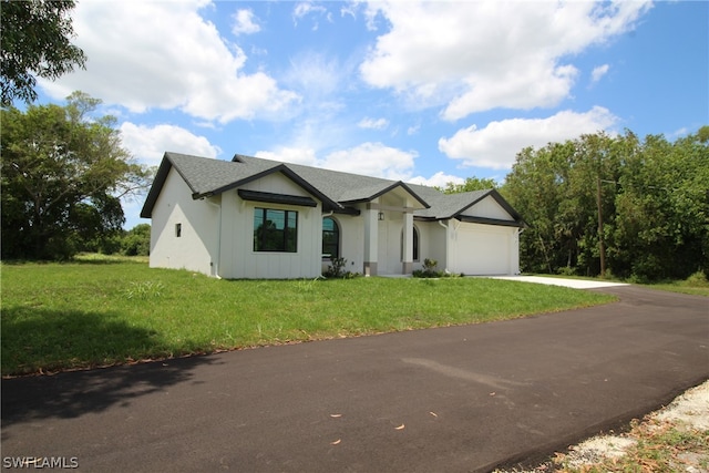 view of front of house with a front lawn and a garage