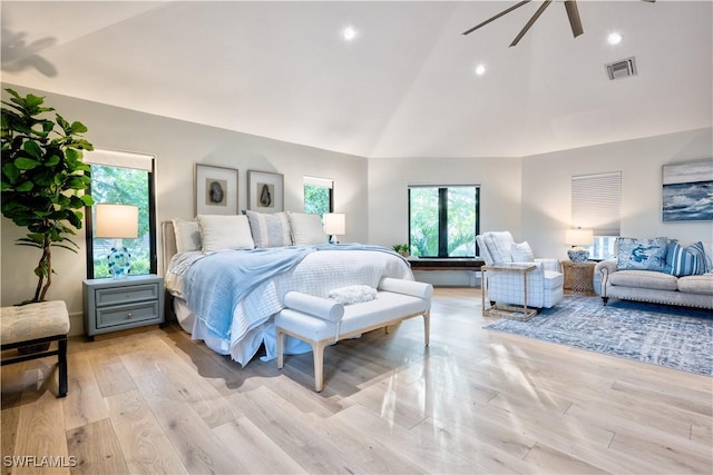 bedroom featuring lofted ceiling, a ceiling fan, visible vents, and light wood finished floors