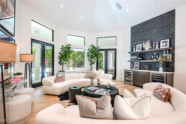 living room with beverage cooler, indoor wet bar, and a wealth of natural light
