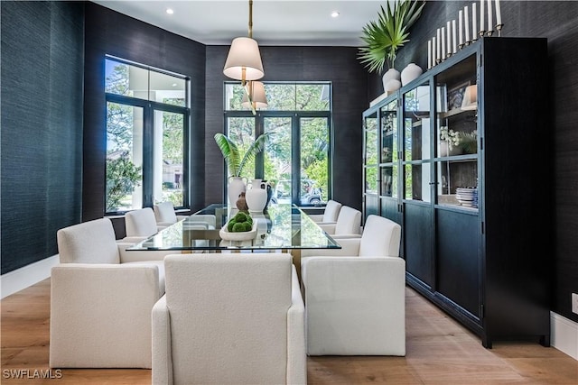 dining room featuring recessed lighting, a high ceiling, and light wood-style flooring