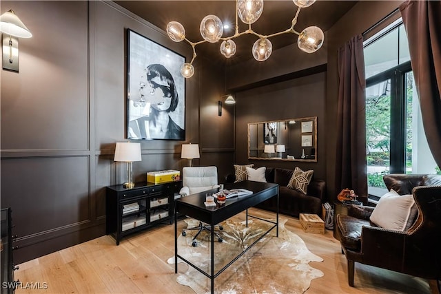 office space with a decorative wall and wood finished floors