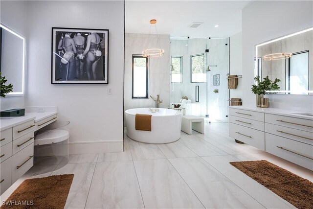 bathroom with a shower with shower door, visible vents, baseboards, a soaking tub, and vanity