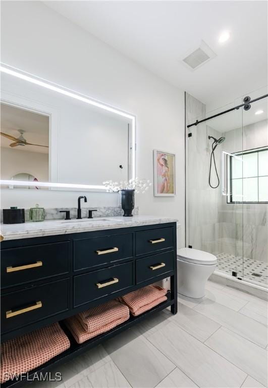 full bathroom with vanity, toilet, visible vents, and a stall shower