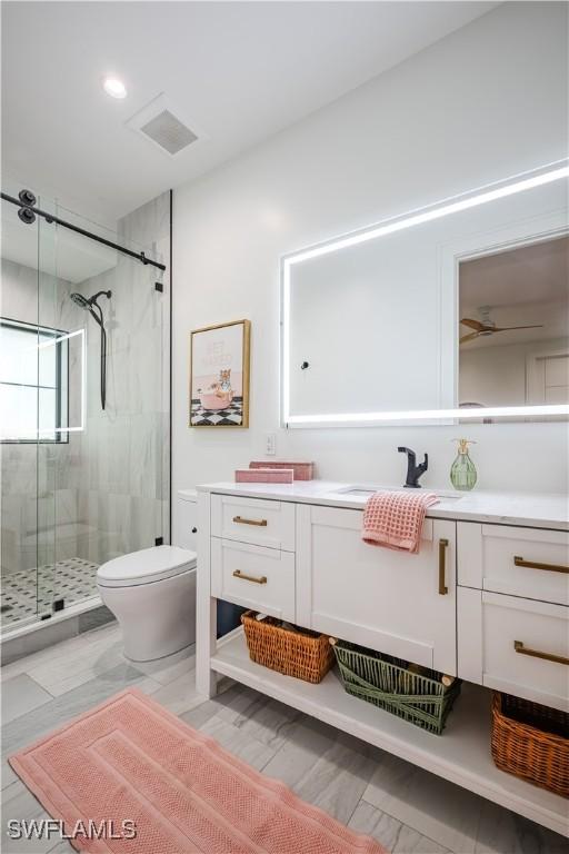 full bath featuring visible vents, a shower stall, vanity, and toilet