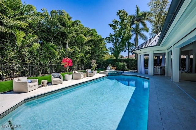 view of pool featuring a patio, a fenced backyard, and a pool with connected hot tub