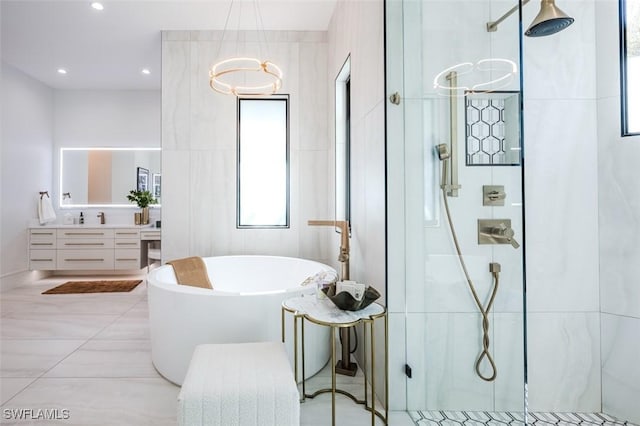 bathroom with tile walls, recessed lighting, tiled shower, a soaking tub, and vanity