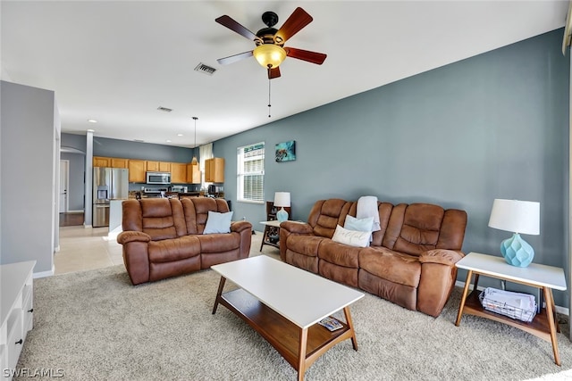 living room with ceiling fan and light colored carpet