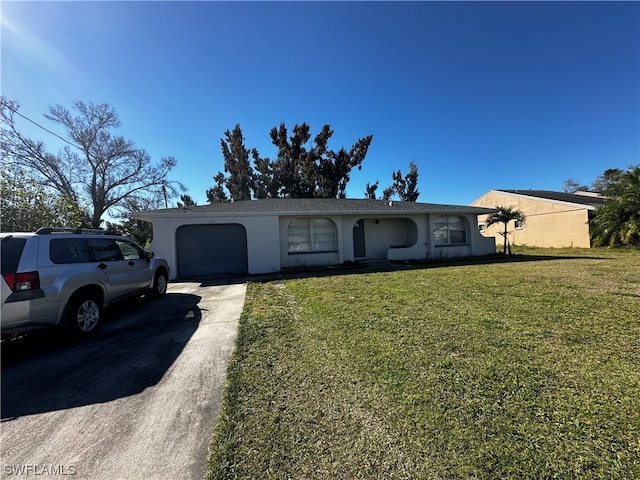 single story home featuring a front lawn and a garage