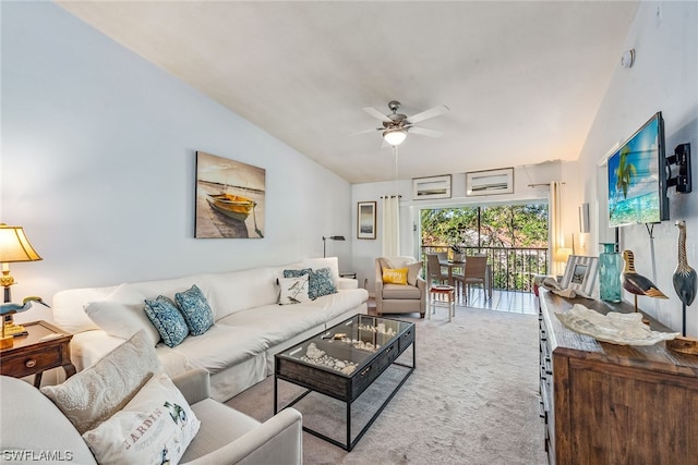 living room featuring ceiling fan, light carpet, and vaulted ceiling