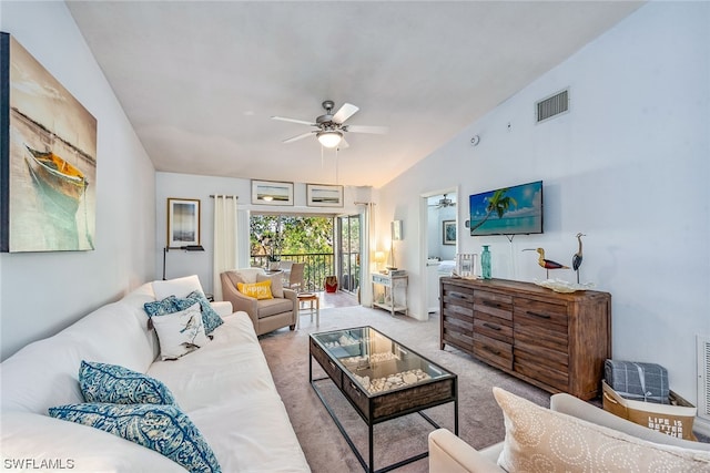 carpeted living room with ceiling fan and lofted ceiling