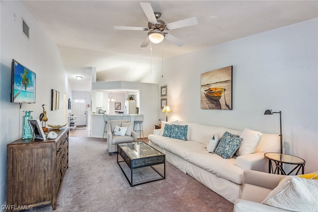 carpeted living room featuring ceiling fan and lofted ceiling