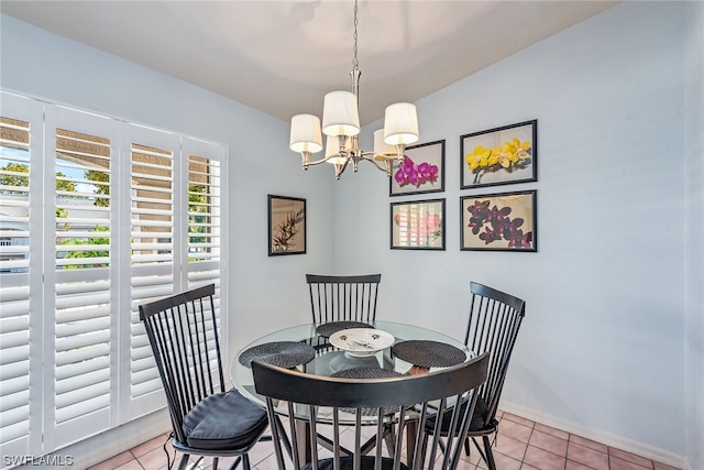 tiled dining area with a chandelier