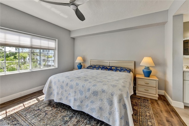 bedroom with ceiling fan and hardwood / wood-style floors