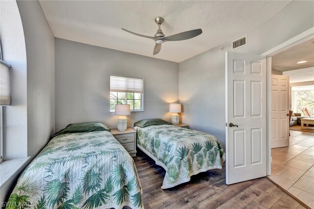 tiled bedroom with ceiling fan