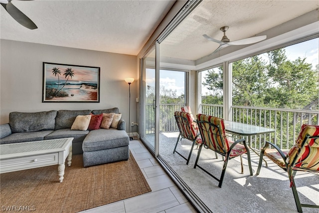 sunroom / solarium featuring ceiling fan and plenty of natural light