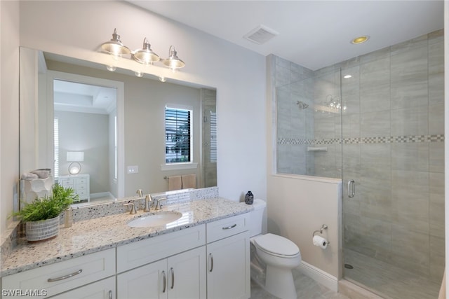 bathroom with oversized vanity, toilet, and a shower with door