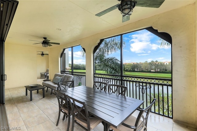 sunroom / solarium featuring ceiling fan