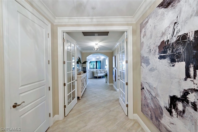 hall with french doors, light tile flooring, and ornamental molding