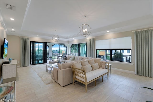 tiled living room with an inviting chandelier and a raised ceiling