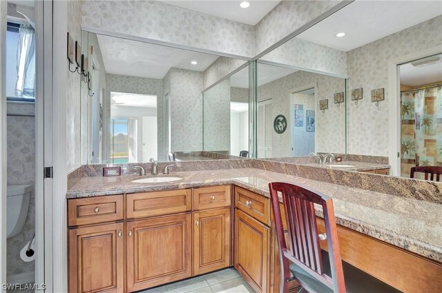 bathroom with tile patterned floors, vanity, and toilet