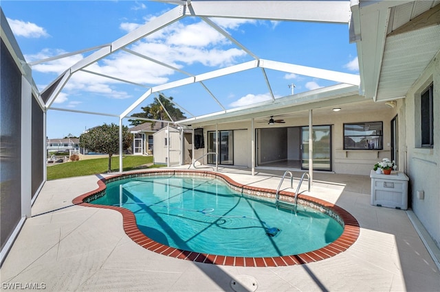 view of pool with glass enclosure and a patio