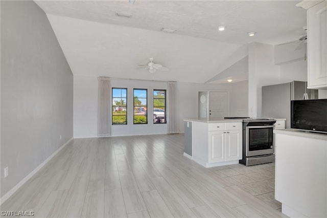 kitchen featuring stainless steel range, white cabinets, light hardwood / wood-style floors, and vaulted ceiling