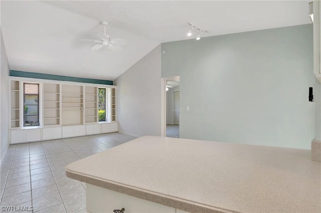 interior space with ceiling fan, lofted ceiling, and track lighting