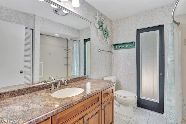 bathroom with tile patterned floors, walk in shower, vanity, and toilet