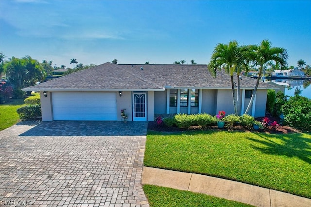 single story home with a garage and a front lawn