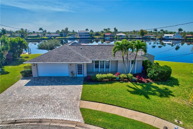 single story home featuring a water view, a garage, and a front lawn