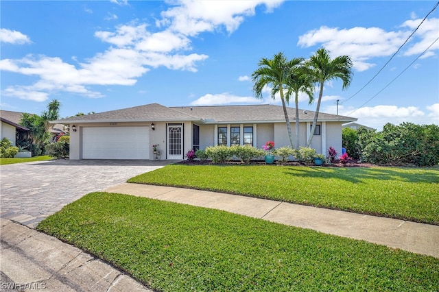 single story home featuring a garage and a front lawn