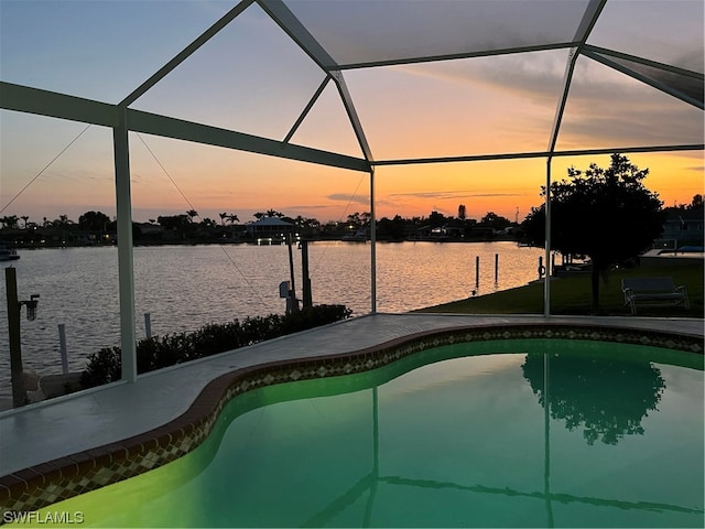 pool at dusk with glass enclosure and a water view