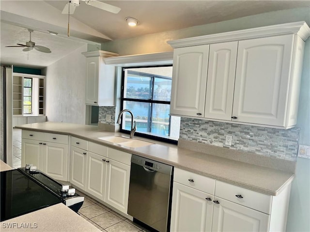 kitchen with dishwashing machine, sink, light tile patterned floors, white cabinets, and decorative backsplash