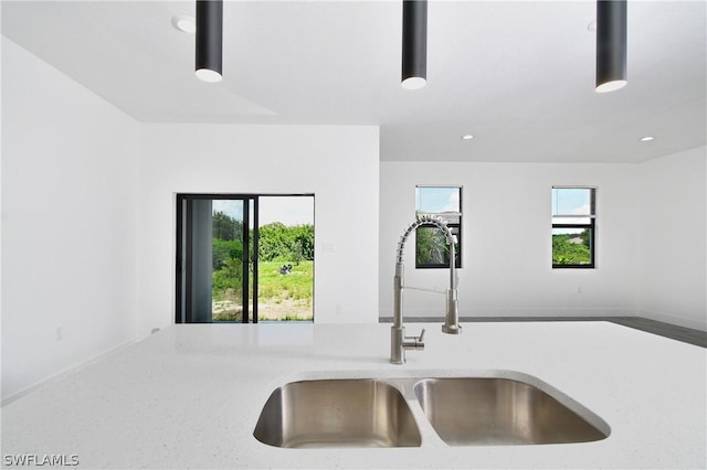 kitchen featuring plenty of natural light and sink