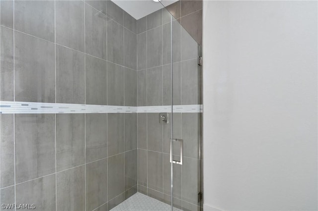 bathroom with a shower with shower door