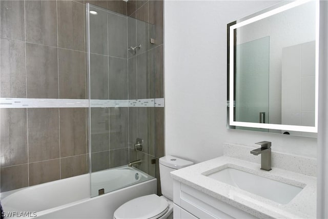 full bathroom with toilet, vanity, and tiled shower / bath combo