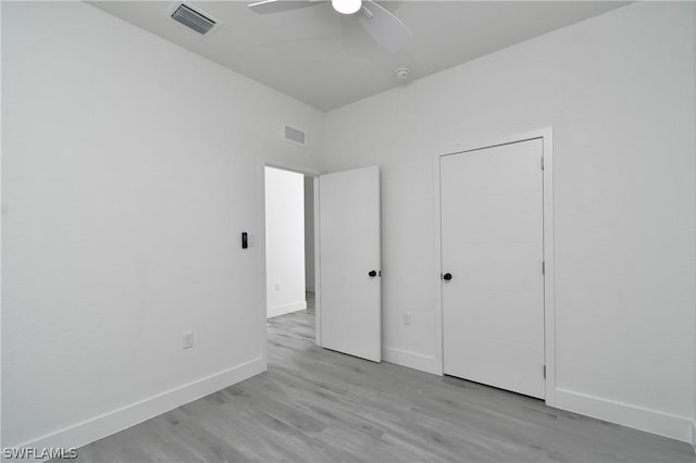 unfurnished bedroom with ceiling fan and light wood-type flooring